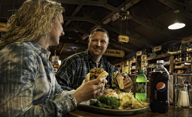 Couple Enjoying Burger | Westgate River Ranch Resort Dining