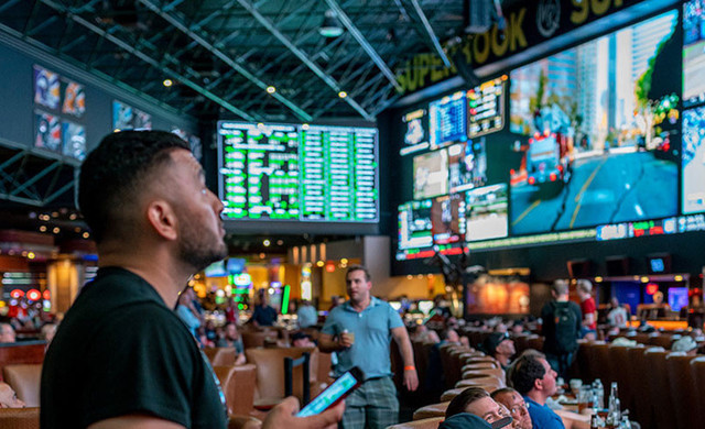 Race & Sports SuperBook | Man Looking at TV at Superbook Bar