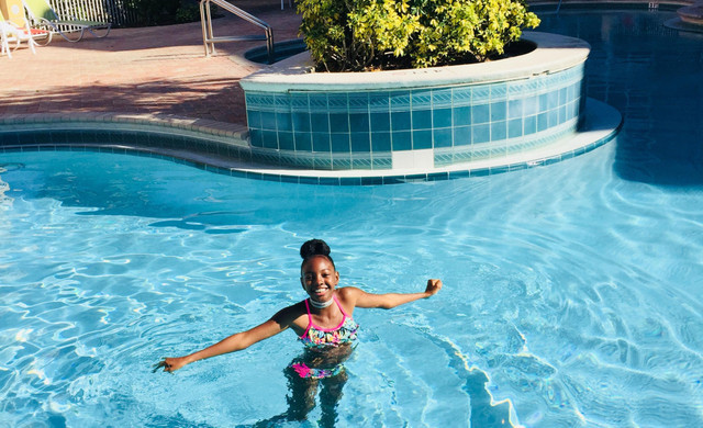 Vacation Packing List Blog - Girl in Pool