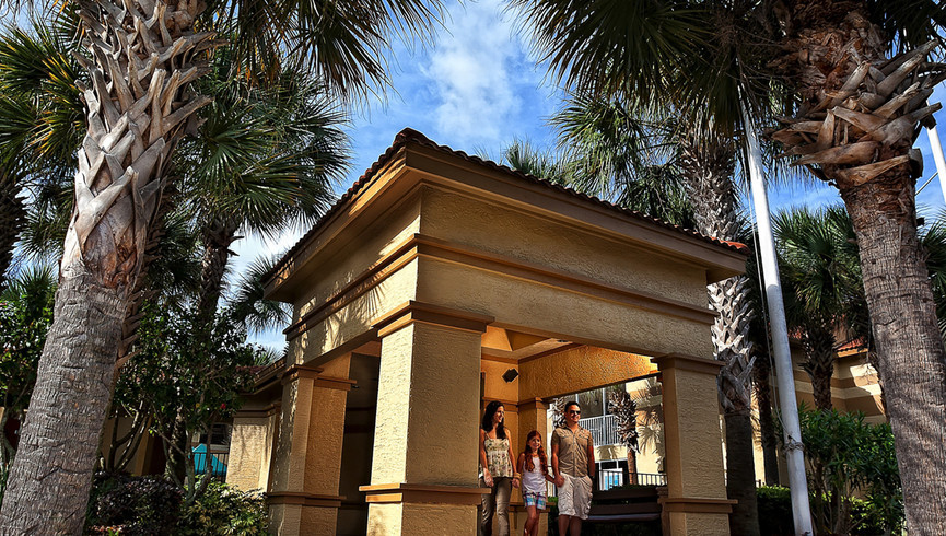 Westgate Blue Tree Resort Directory | Family Standing Under Shade Next to Pool