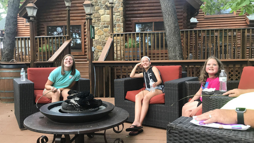 Westgate Branson Woods Resort | Family Sitting Next to Firepit Outside