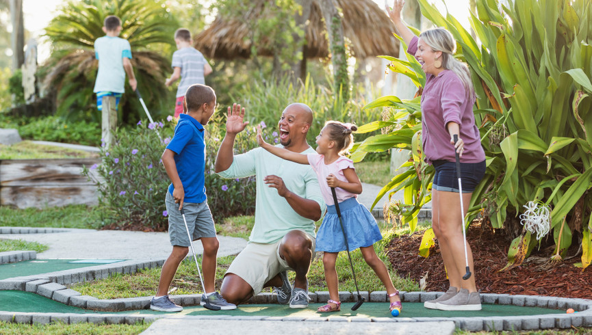 family playing mini golf - westgate vacation villas resort