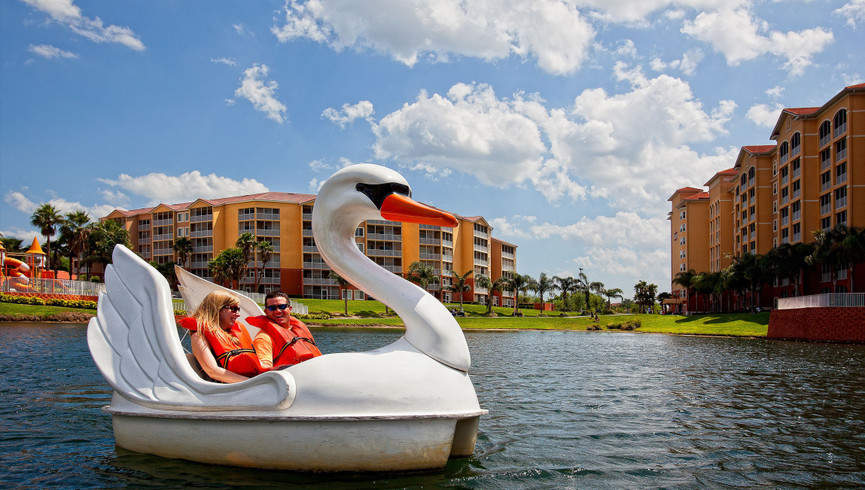 family on swan boat at resort near disney world - westgate vacation villas resort