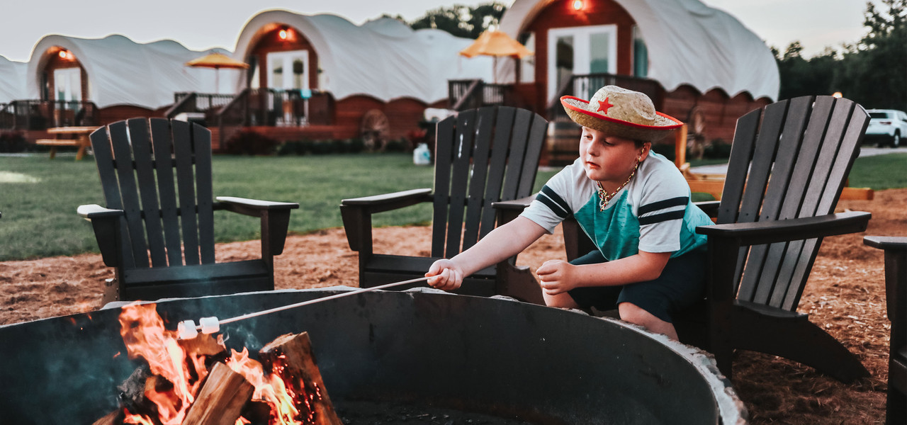 River Ranch Hidden Perks - Westgate River Ranch Resort & Rodeo - Guy roasting marshmellow