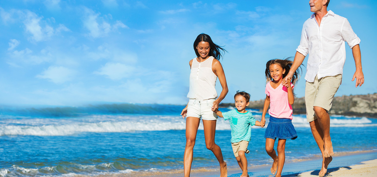 family walking on beach sunrise - westgate resorts