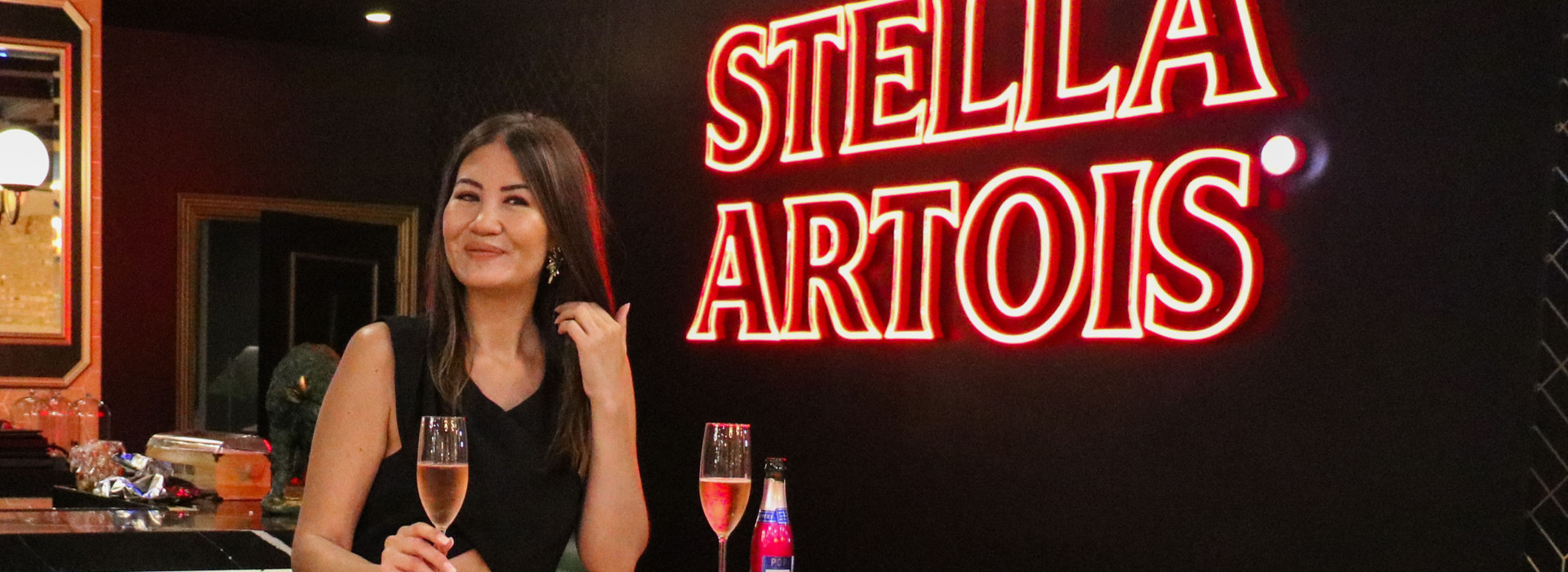 woman with drink at bar tudor city tavern - westgate new york city