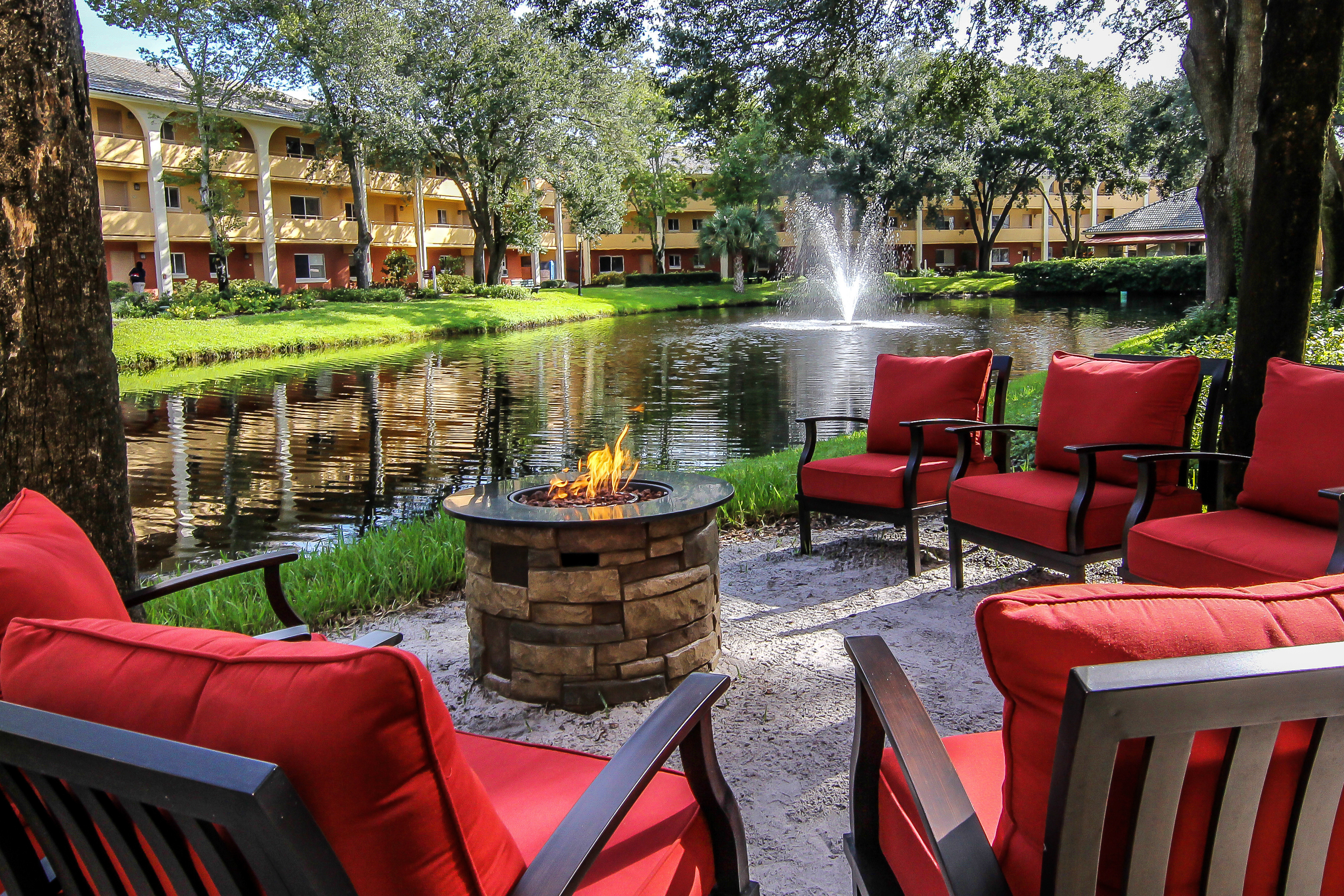 Fire pit with chairs in front of lake at one of our leisure hotels close to Seaworld Orlando | Westgate Leisure Resort | Westgate Resorts