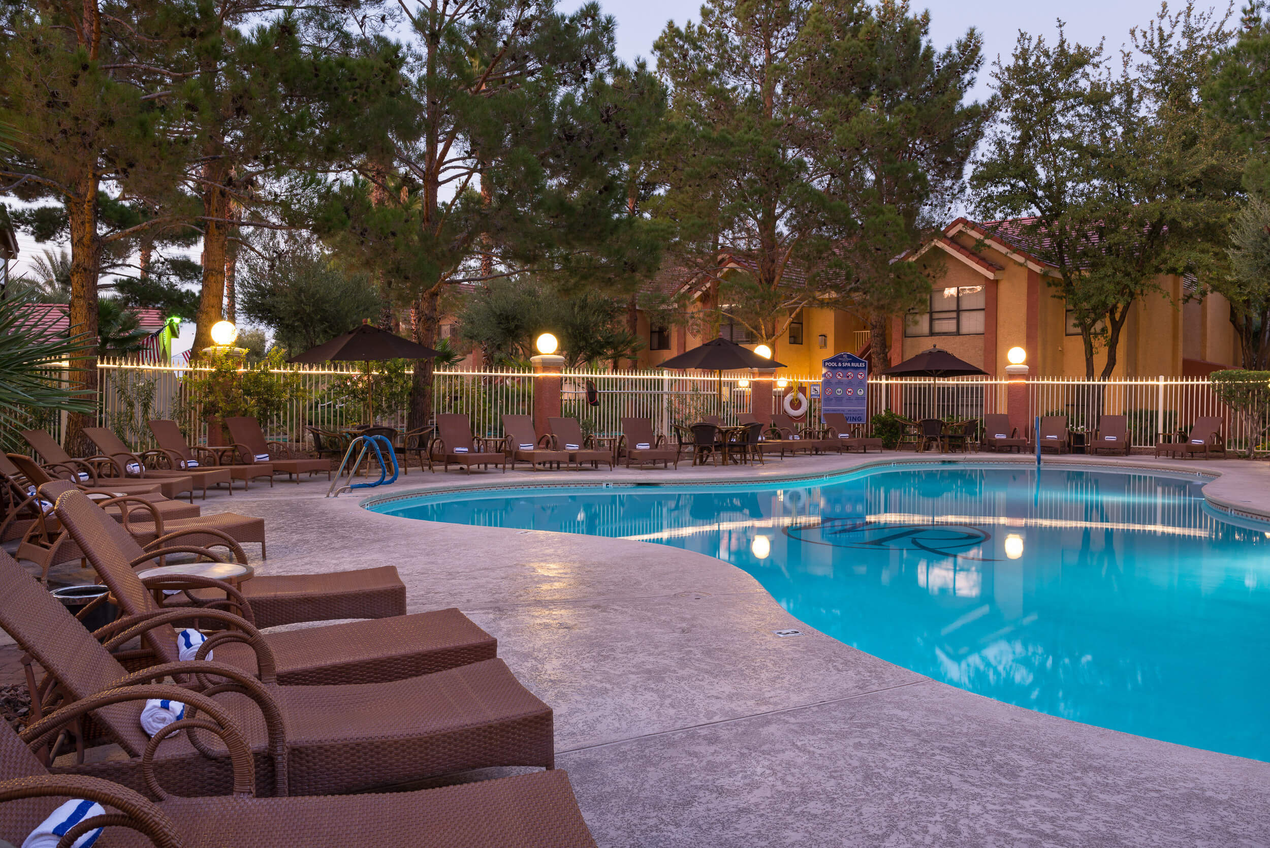 Heated outdoor pool with lounge chairs at night | Westgate Flamingo Bay Resort