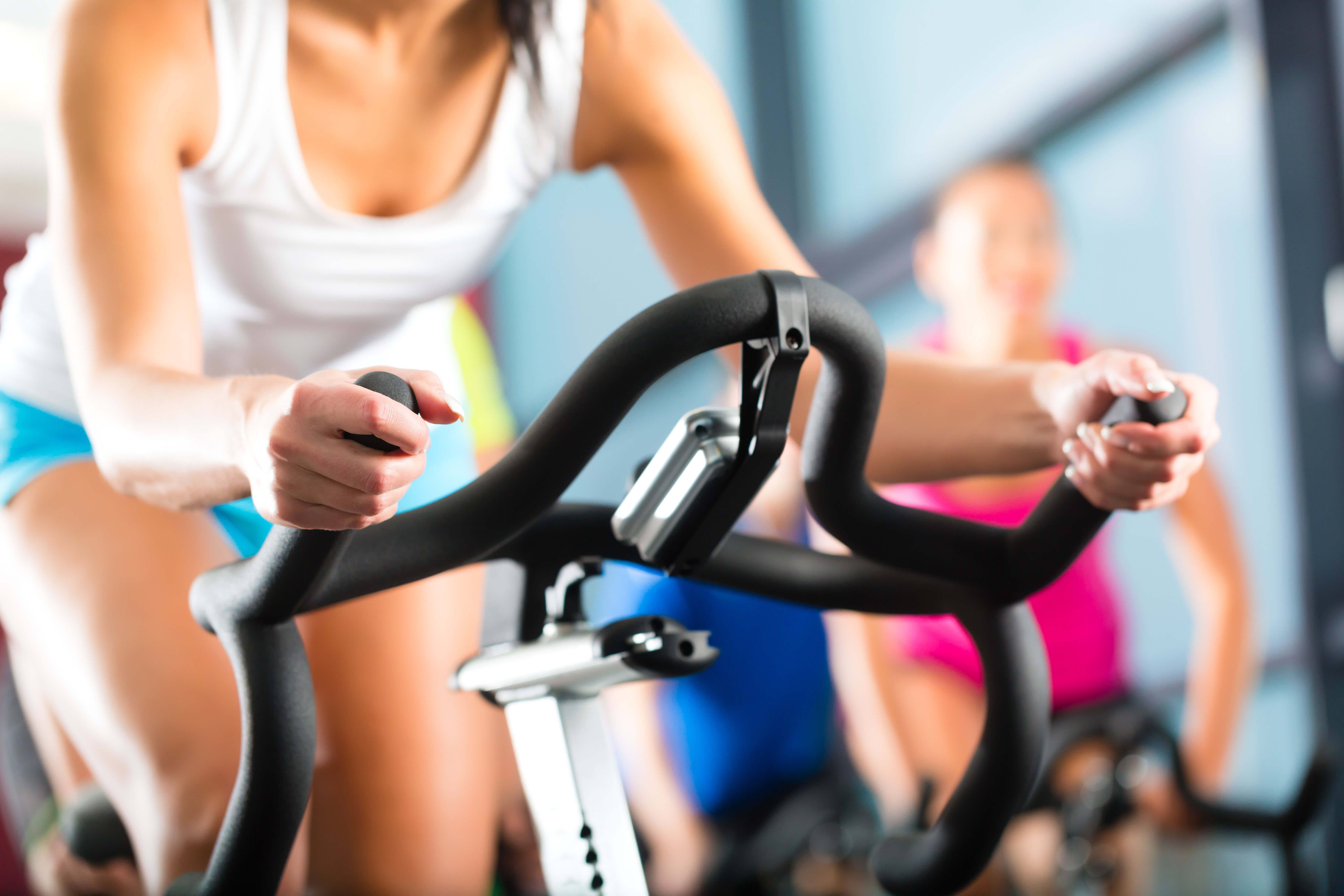 Guest riding stationary exercise bike at Fitness Center | Westgate Historic Williamsburg Resort