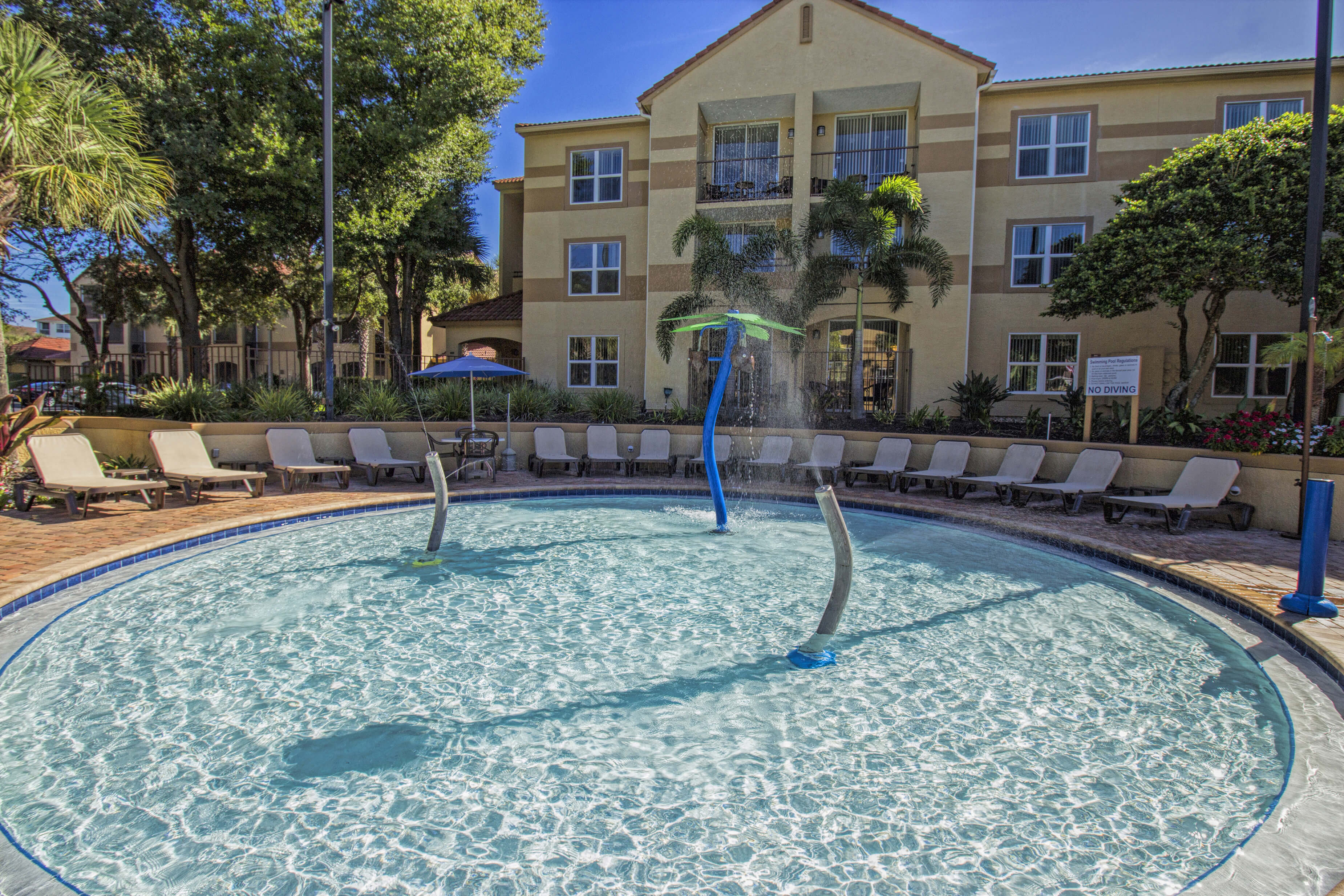 Children's water play area surrounded by lounge chairs | Westgate Blue Tree Resort