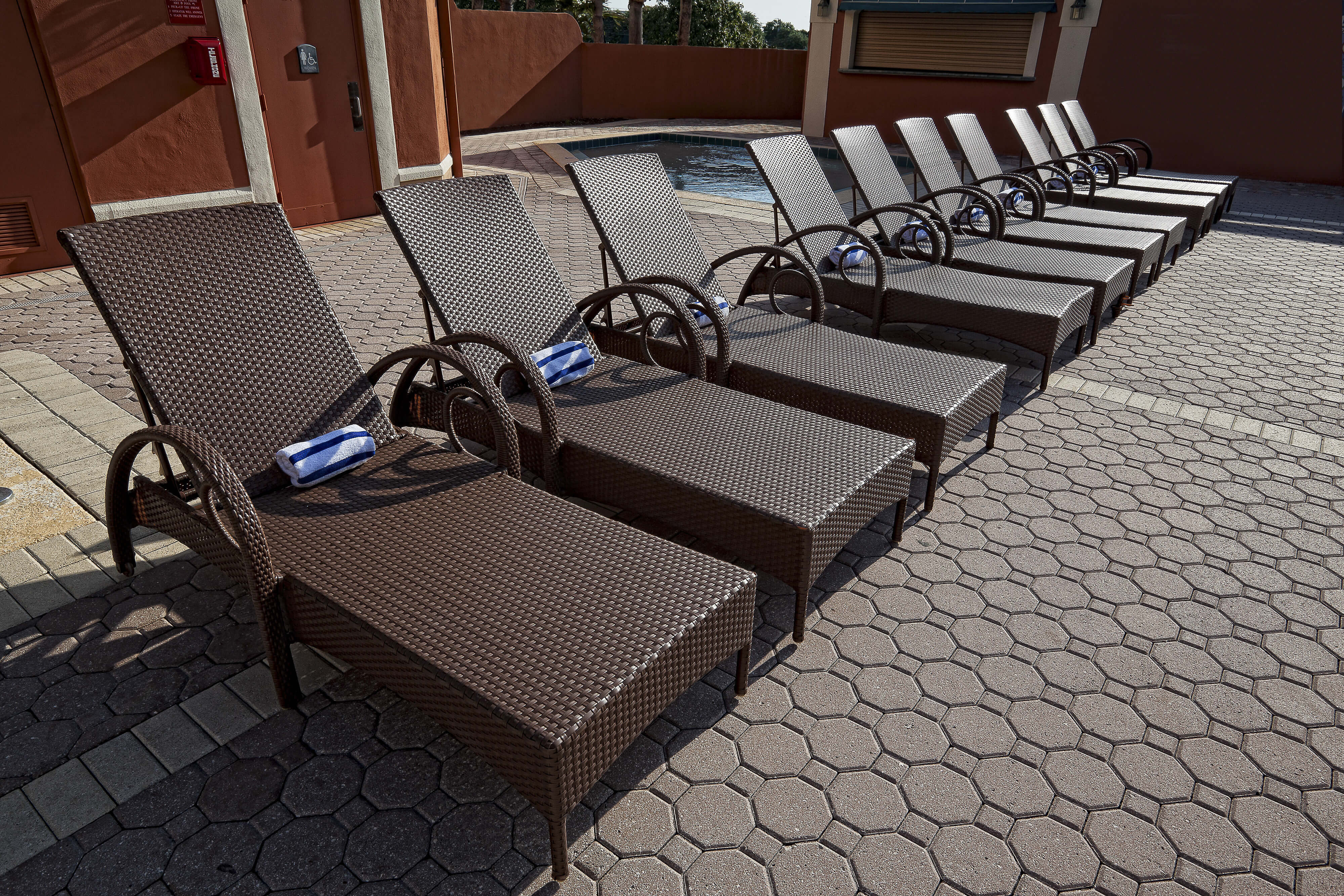 Row of lounge chairs on outdoor pool deck | Westgate Towers Resort