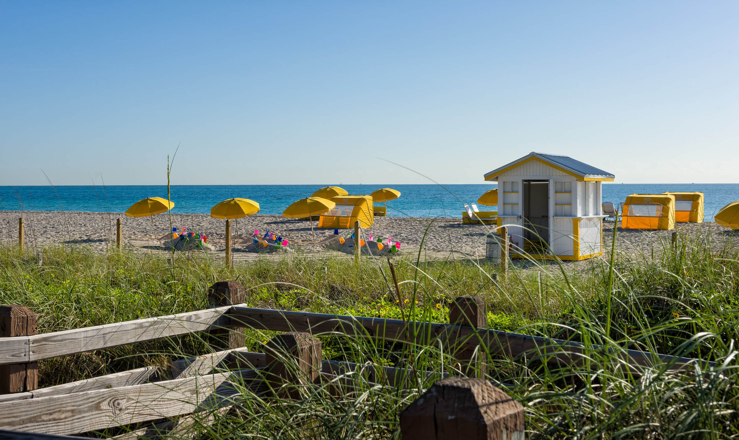 White-sand beach with umbrellas and cabanas | Westgate South Beach Oceanfront Resort