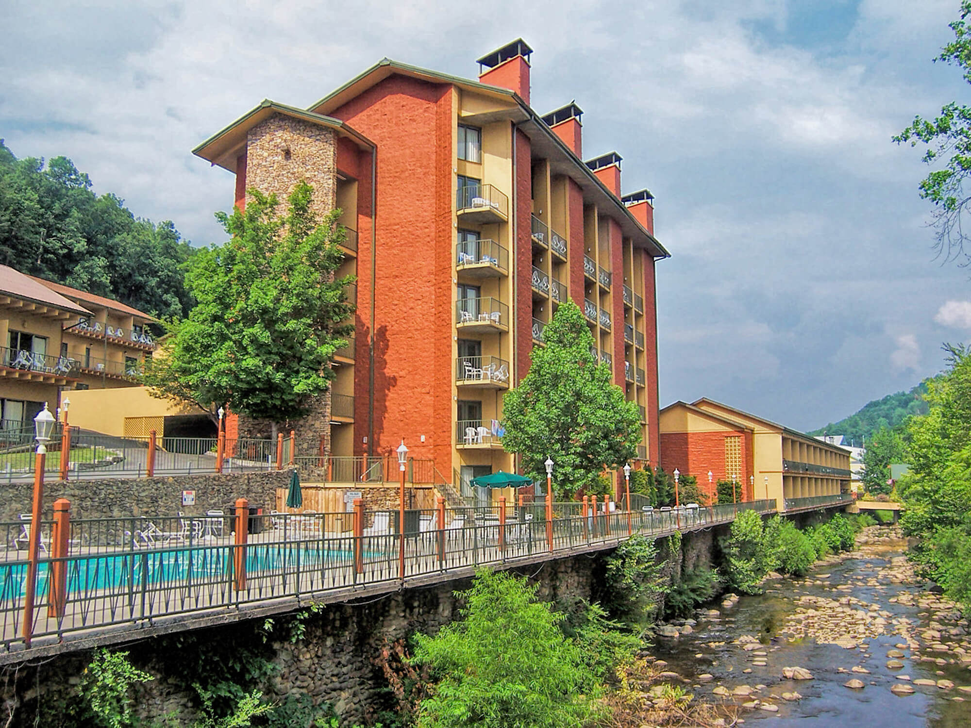 Heated outdoor pool with resort building in background | River Terrace Resort & Convention Center | Westgate Resorts