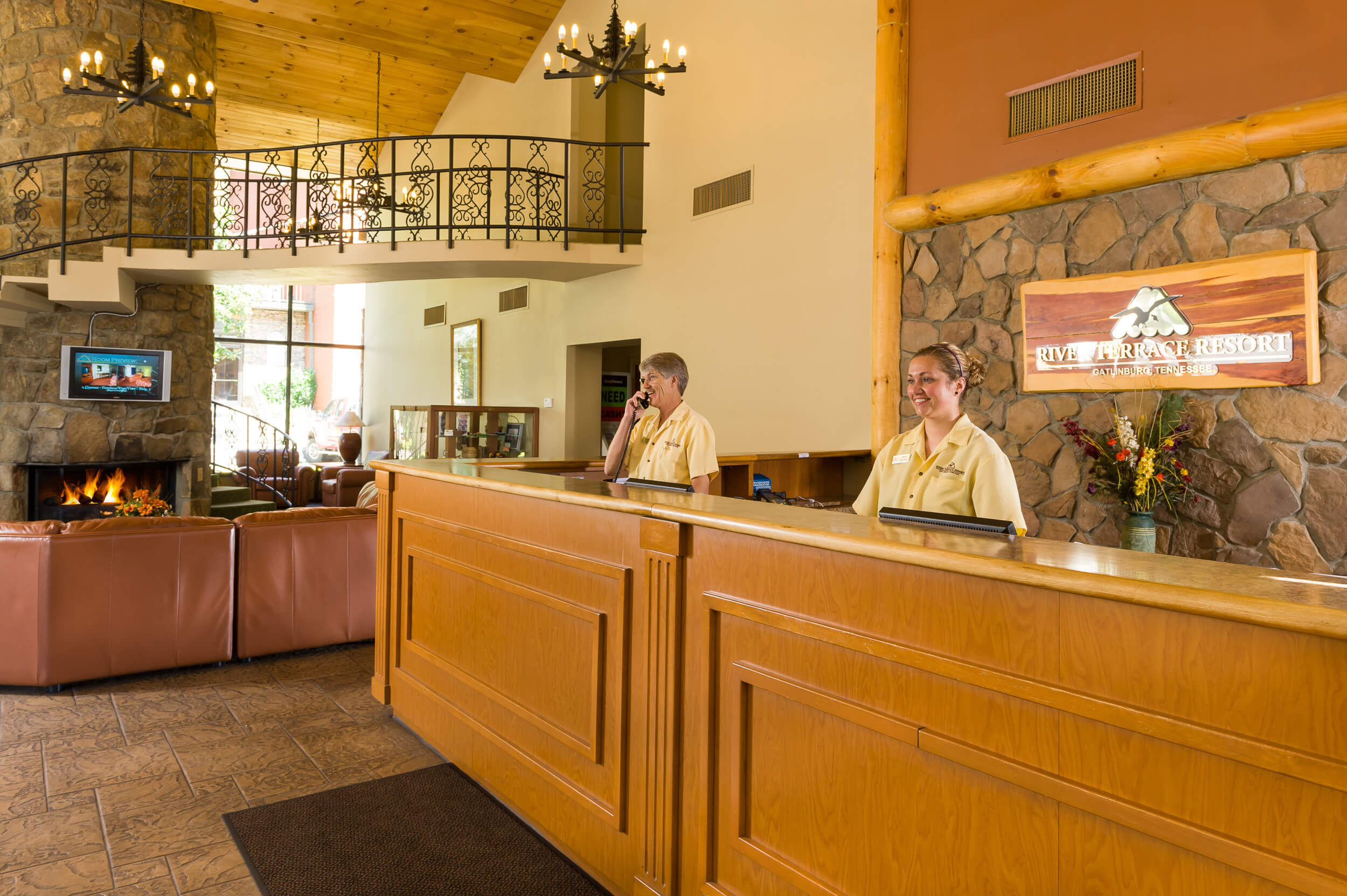 Lobby with front desk and fireplace at our Gatlinburg convention center hotel | River Terrace Resort & Convention Center | Westgate Resorts