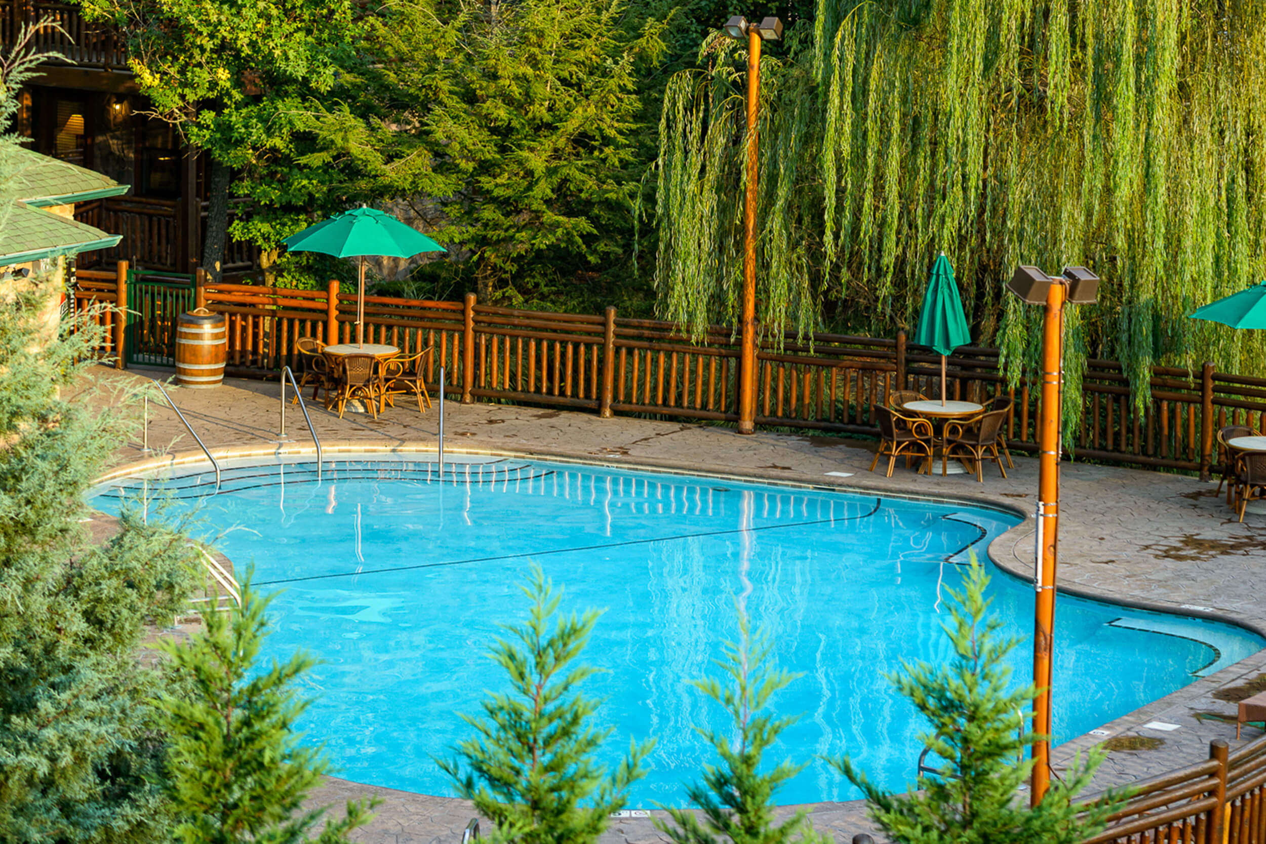 Outdoor pool with tables, chairs and umbrellas | Westgate Smoky Mountain Resort & Spa