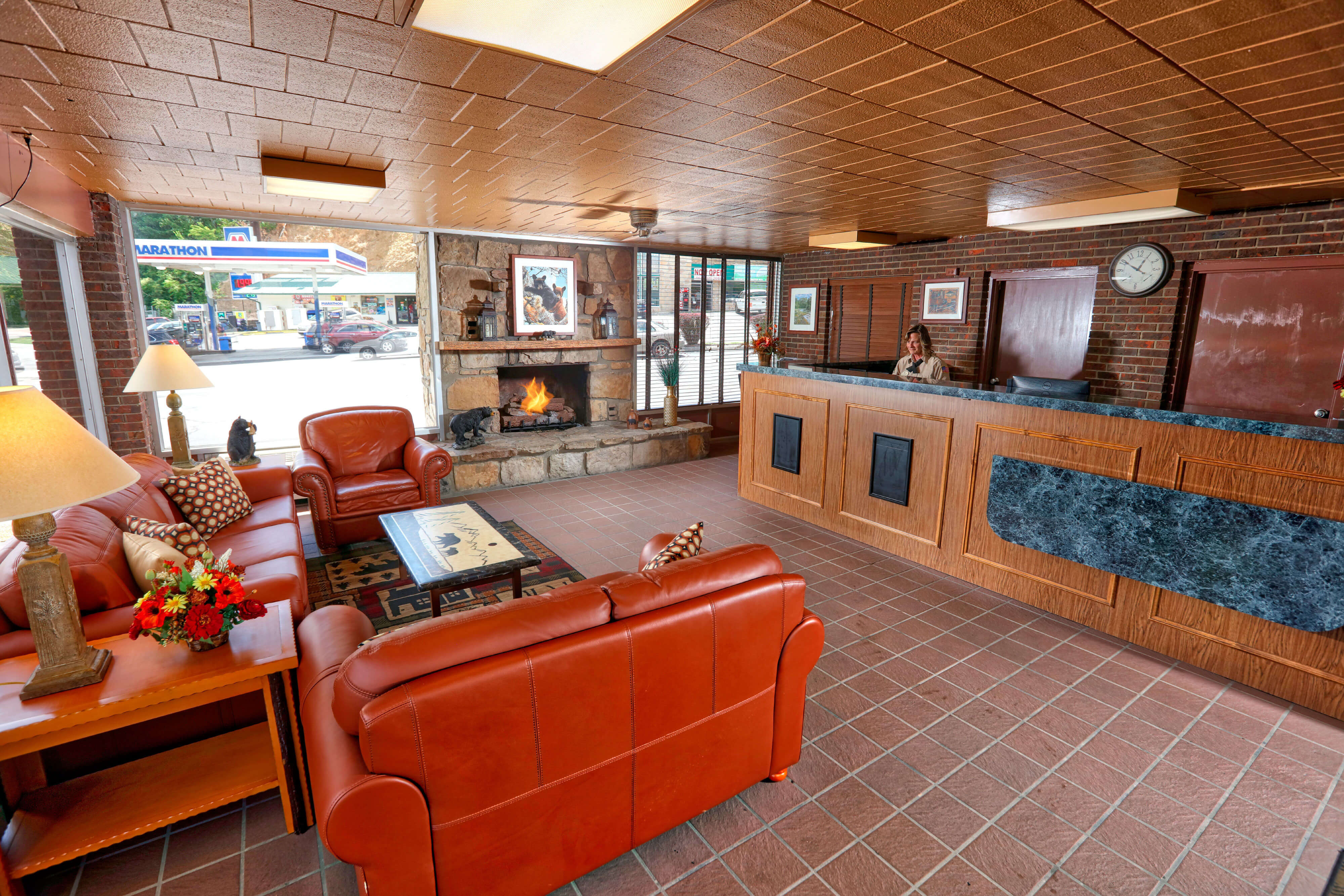 Lobby with front desk and fireplace at one of our Pigeon Forge Resorts | Wild Bear Inn | Westgate Smoky Mountain Resorts