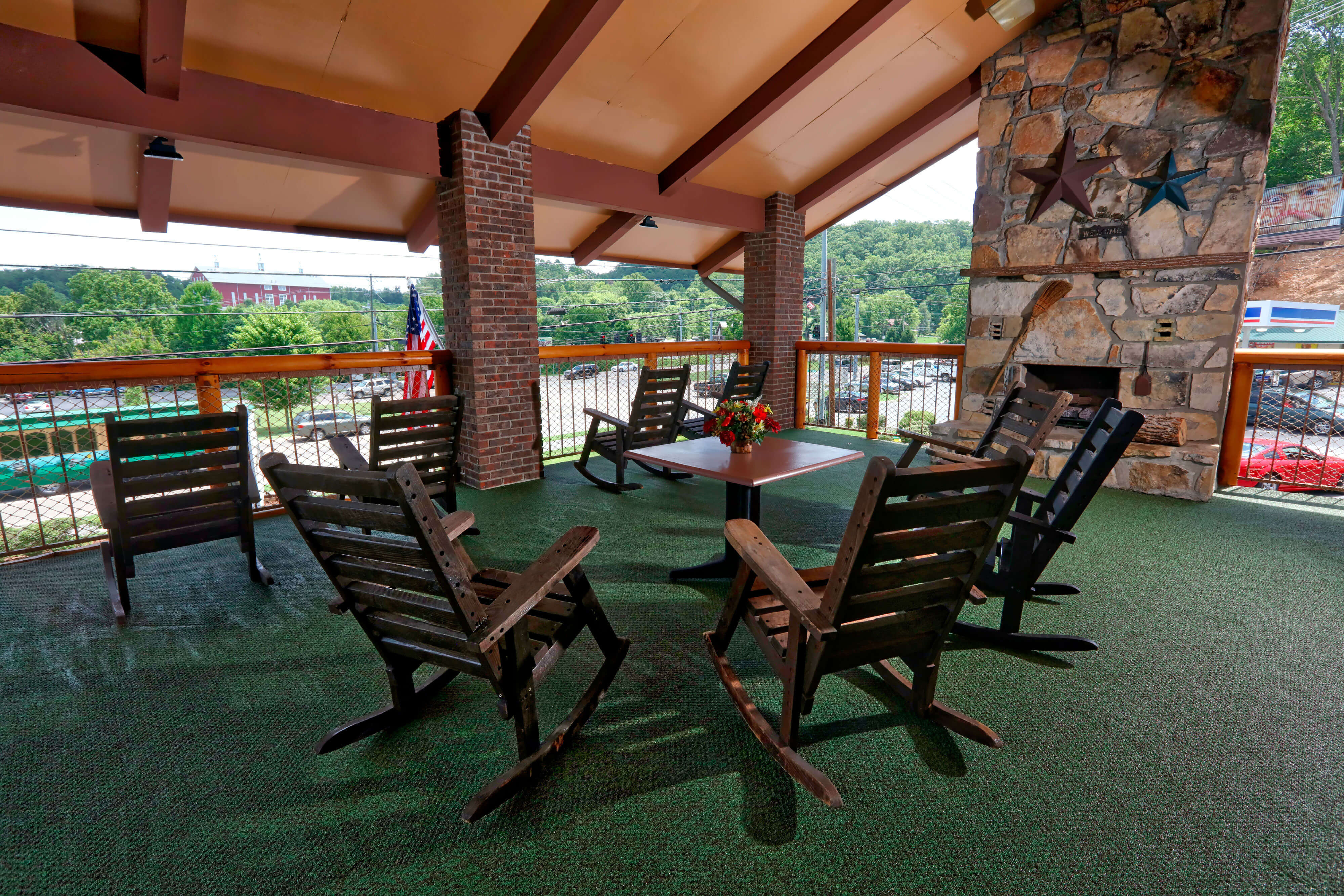 Inviting outdoor deck with rocking chairs and fireplace | Wild Bear Inn | Westgate Resorts in the Smoky Mountains