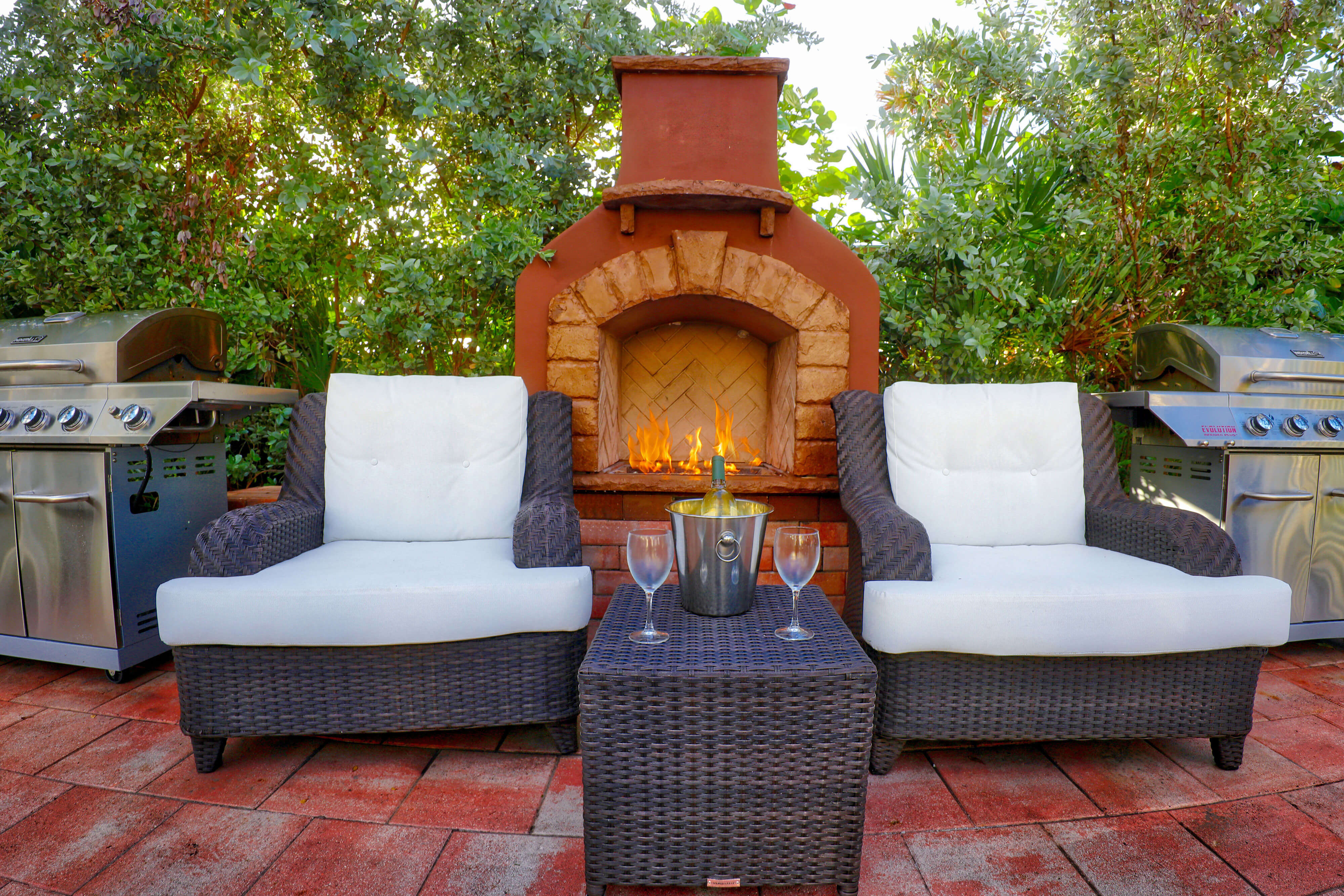 Outdoor deck with lounge chairs, wine, fireplace and gas grill | Westgate South Beach Oceanfront Resort